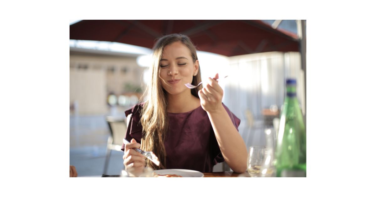 笑顔で食事をとる女性のイメージ